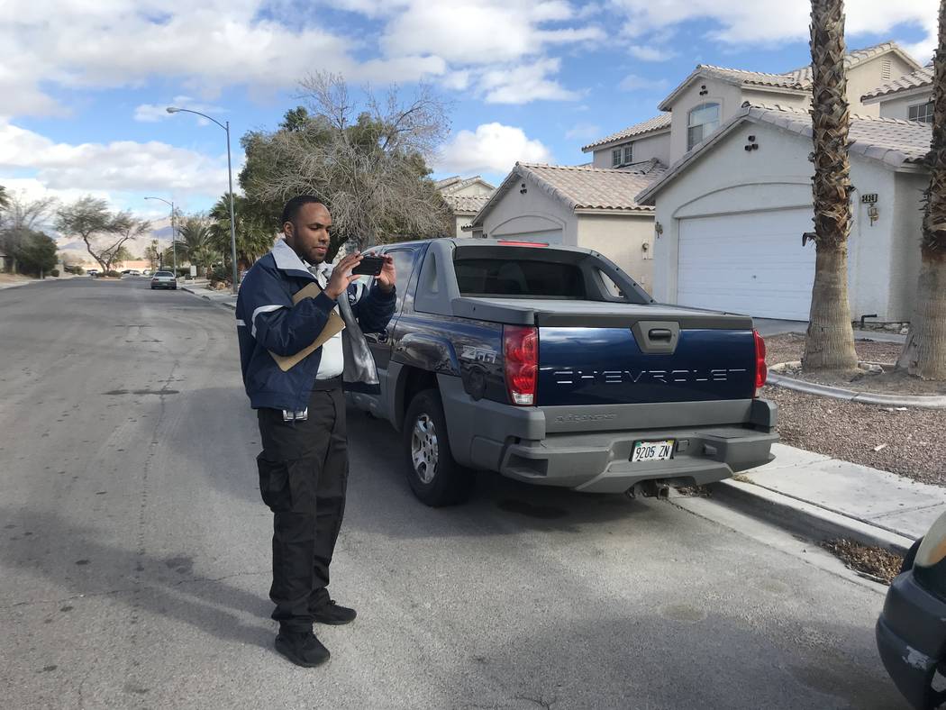 Anthony Coleman, a parking enforcement officer with the City of North Las Vegas, observes what seems to be an abandoned vehicle in a residential area at the northwest end of the city. (Mia Sims/ L ...