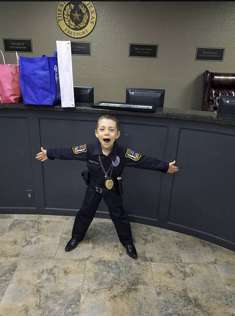 In this Feb. 7, 2019 photo provided by Freeport Police Department, 6-year-old Abigail Arias, who is battling cancer, poses for a picture after being sworn in as a Texas police officer by Freeport ...