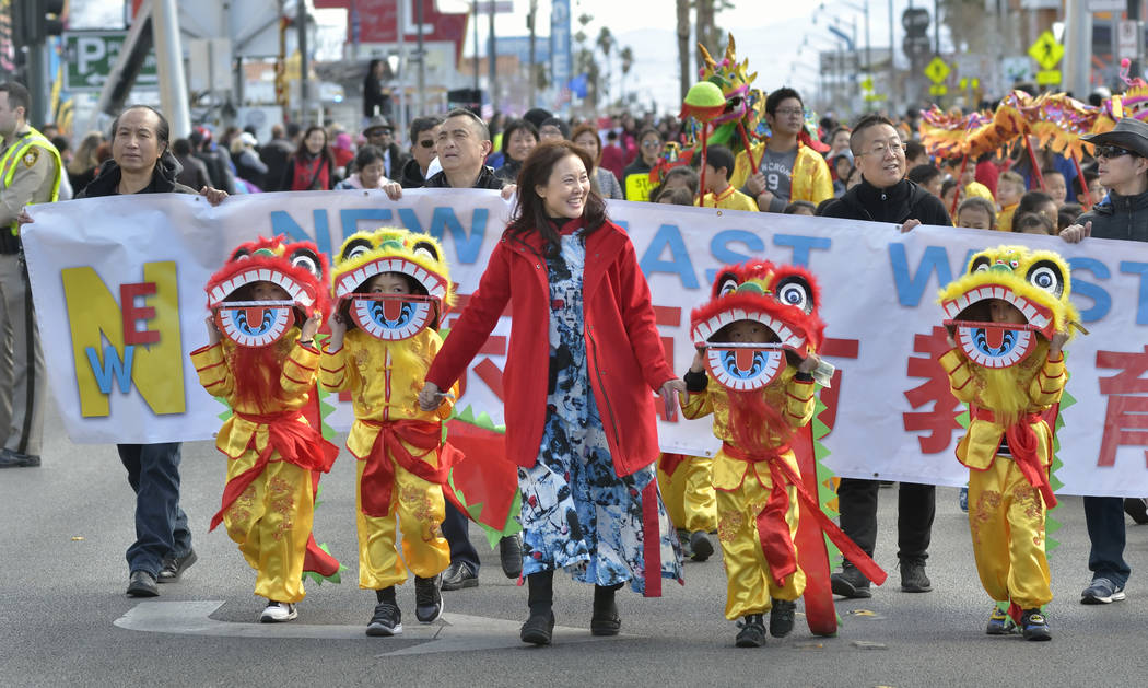Principal Susan Wang, center, leads a group from the New East West Learning Center during a parade which was part of Chinese New Year celebrations on Fremont Street in Las Vegas on Saturday, Feb. ...