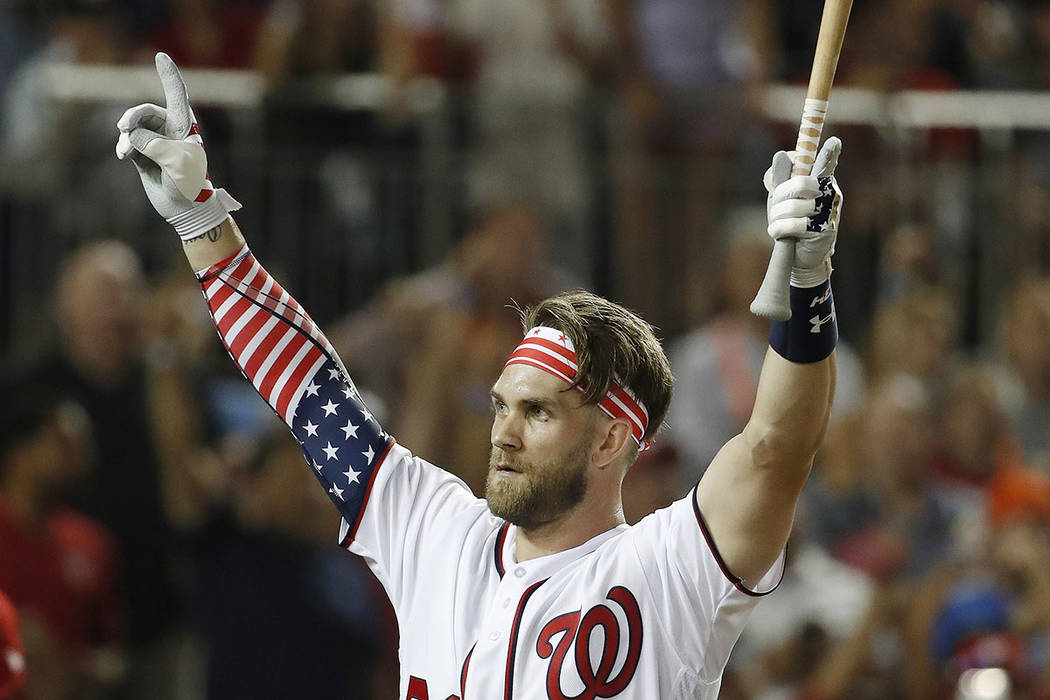 Washington Nationals Bryce Harper (34) signals to the crowd as he walks back to the dugout during the MLB Home Run Derby, at Nationals Park, Monday, July 16, 2018 in Washington. The 89th MLB baseb ...
