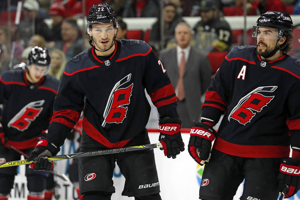 Carolina Hurricanes' Brett Pesce (22) and Justin Faulk (27) skate away from the bench against the Vegas Golden Knights during the first period of an NHL hockey game, Friday, Feb. 1, 2019, in Ralei ...