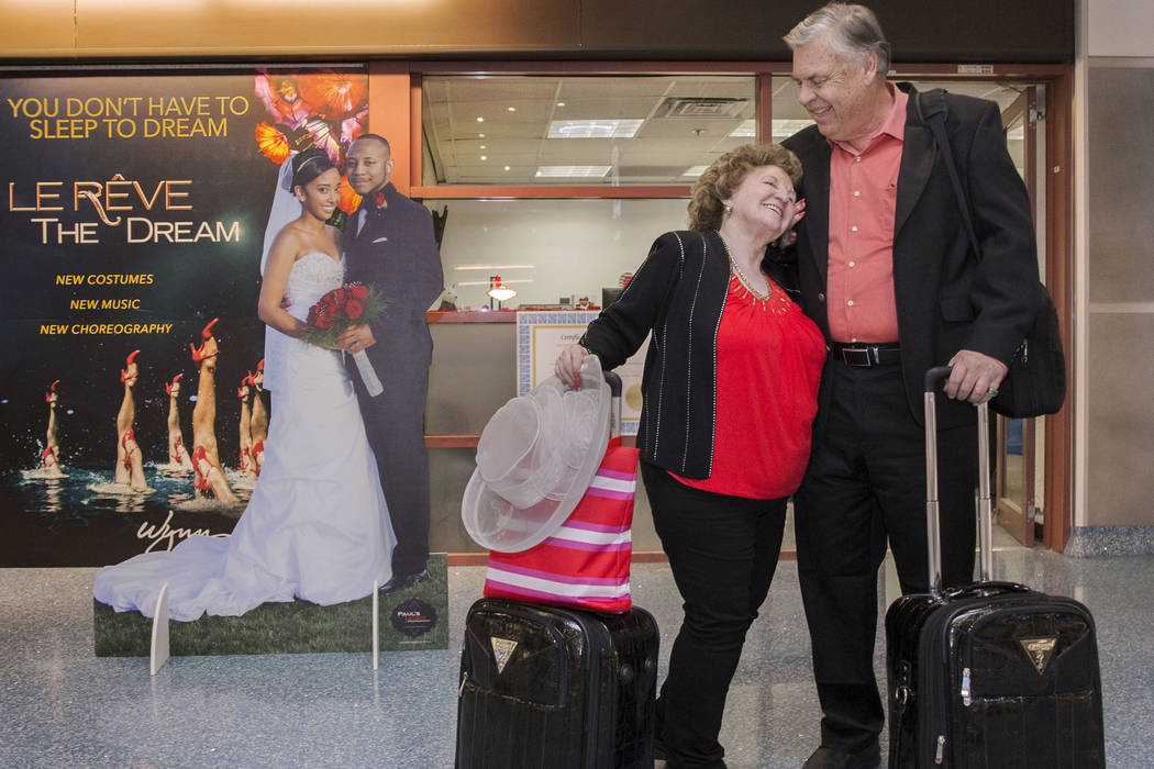 Jay Shade, right, from Phoenix and his fiancée TC celebrate after getting their marriage license at a Clark County pop-up office in the baggage claim area at Terminal 1 on Wednesday, Feb. 13, ...