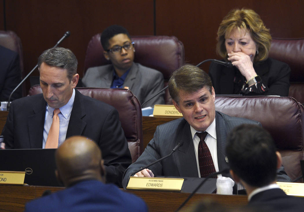 Republican Assemblyman Chris Edwards asks a question of state Senate Majority Leader Kelvin Atkinson and William Rosen, with Everytown for Gun Safety, during a hearing for Senate Bill 143 at the N ...