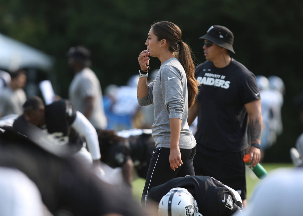 Oakland Raiders strength and conditioning assistant Kelsey Martinez runs the team's warm up drills at their NFL training camp in Napa, Calif., Tuesday, Aug. 7, 2018. Heidi Fang Las Vegas Rev ...