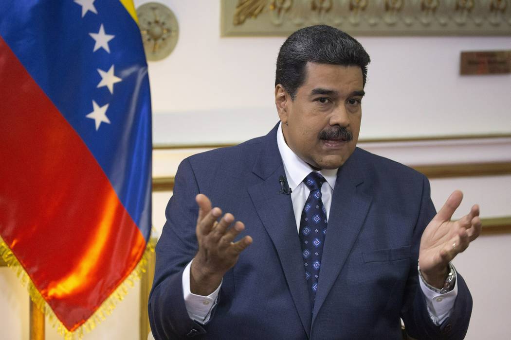Venezuela's President Nicolas Maduro speaks during an interview with The Associated Press at Miraflores presidential palace in Caracas, Venezuela, Thursday, Feb. 14, 2019. Even while criticizing D ...