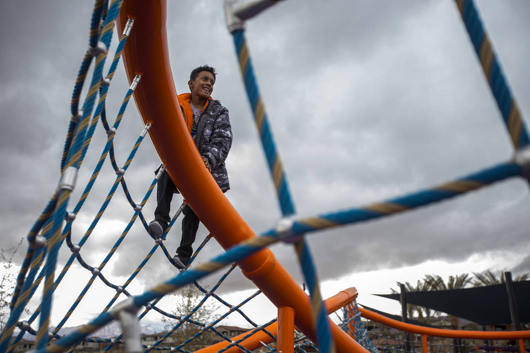Nyko Minnifield, 7, climbs a structure in the hail at Fox Hill Park in Las Vegas, Sunday, Feb. 17, 2019. (Rachel Aston/Las Vegas Review-Journal) @rookie__rae