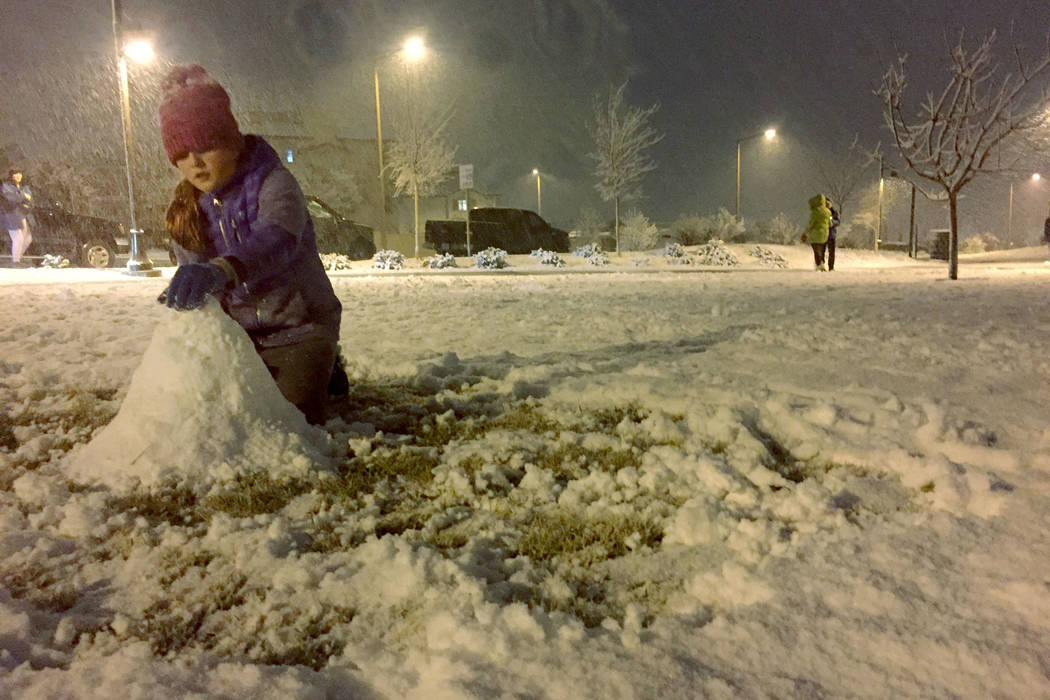 Ellie Prindle, 10, a fifth-grader at Givens Elementary School, makes a snowman Sunday night, Feb.17, 2019, at Fox Hill Park in Summerlin. (Marian Green/Las Vegas Review-Journal)