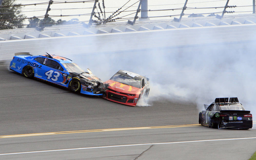 Jamie McMurray, center, crashes into Darrell Wallace Jr. (43) after Kurt Busch, right, spins out from the wreck during the NASCAR Daytona 500 auto race at Daytona International Speedway, Sunday, F ...