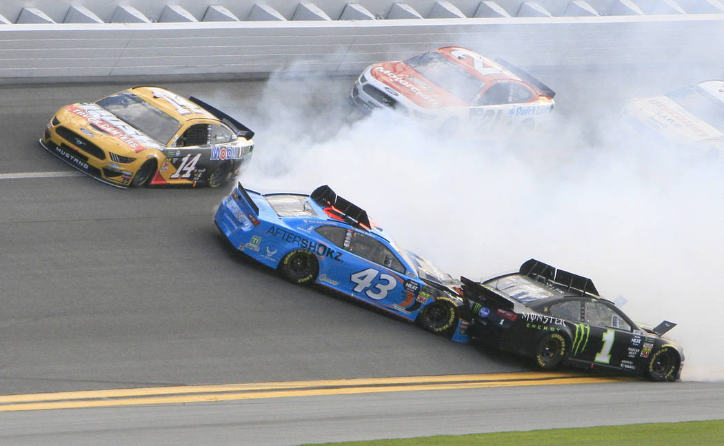 Darrell Wallace Jr. (43) gets caught up in a wreck with Kurt Busch (1) as Clint Bowyer (14) goes high to avoid the crash during a NASCAR Daytona 500 auto race at Daytona International Speedway, Su ...
