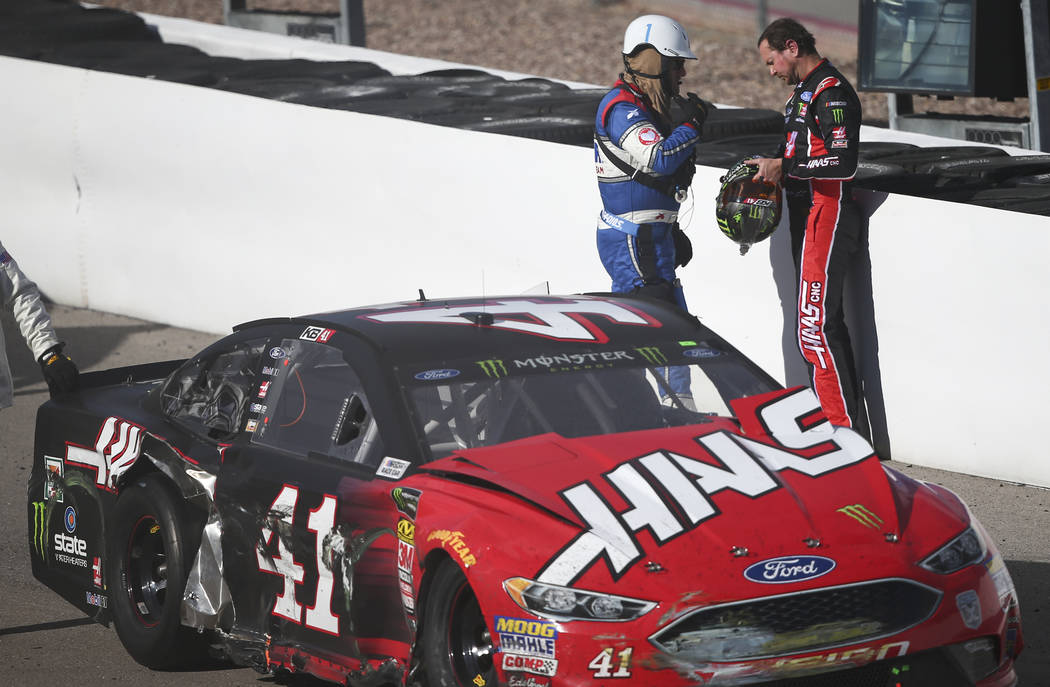 Race officials check on Kurt Busch (41) after he crashed into Chase Elliott (9) during the Monster Energy NASCAR Cup Series Pennzoil 400 auto race at the Las Vegas Motor Speedway in Las Vegas on S ...