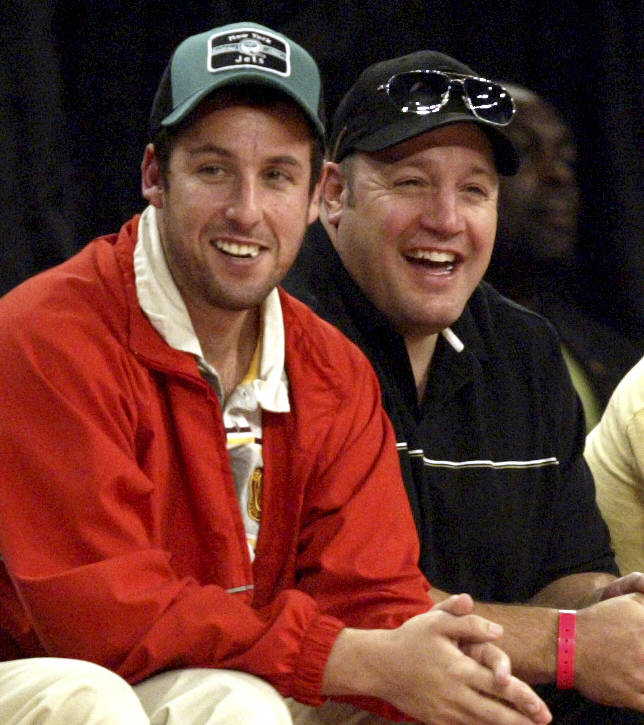 Actor Adam Sandler, left, and Kevin James laugh during the NBA All-Star basketball game at the Thomas & Mack Center Sunday, Feb. 18, 2007, in Las Vegas. Singer Christina Aguilera performs at ha ...