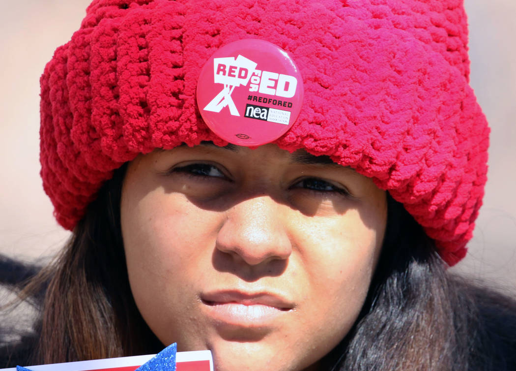 Leslie Long, 15, wears ''Red for Ed'' pin as she demonstrates her support for the Red for Ed movement outside of the Grant Sawyer Building on Monday, Feb. 18, 2019, in Las Vegas. Educators dressed ...