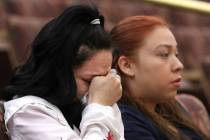 Amber Bustillos, a fiancée of Junior Lopez, a man fatally shot by Las Vegas police in April, weeps as her friend Carla Varela looks on during a public review of Lopez death on Thursday, Feb. ...