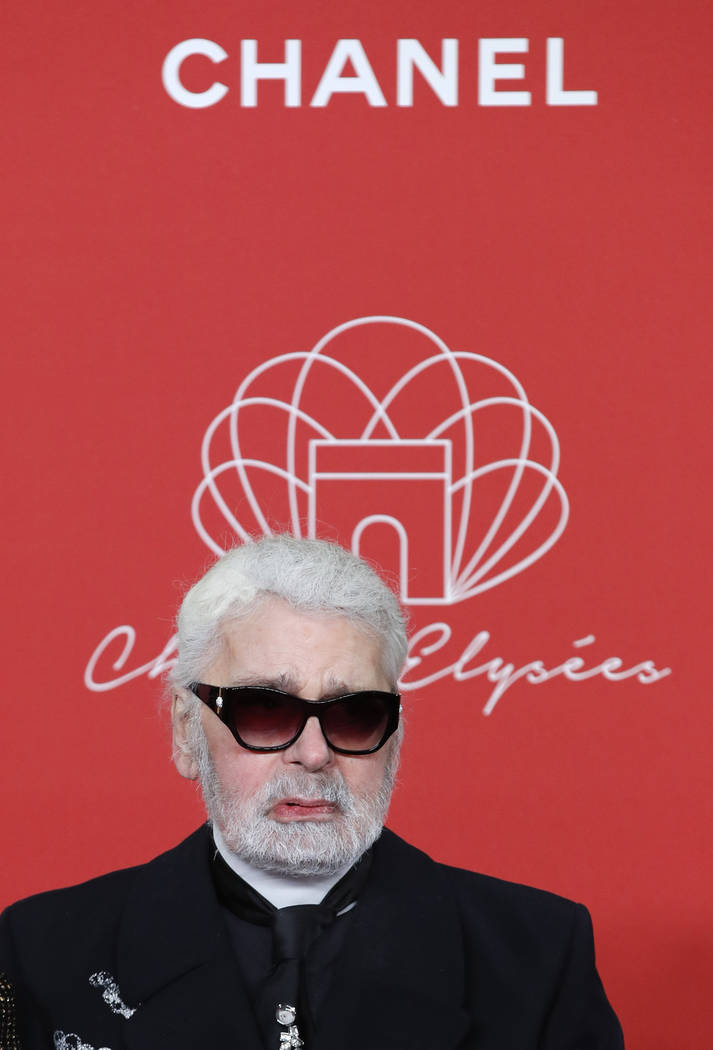 FILE - In this hursday, Nov. 22, 2018 file photo, Karl Lagerfeld poses during the Champs Elysee Avenue illumination ceremony for the Christmas season, in Paris. Chanel’s iconic couturier, K ...
