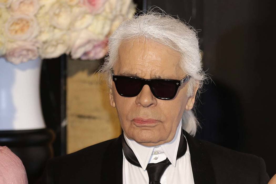 In this Saturday, March 28, 2015 file photo, Karl Lagerfeld poses for photographers as he arrives at the Rose Ball in Monaco. Chanel’s iconic couturier, whose accomplished designs as well as tra ...