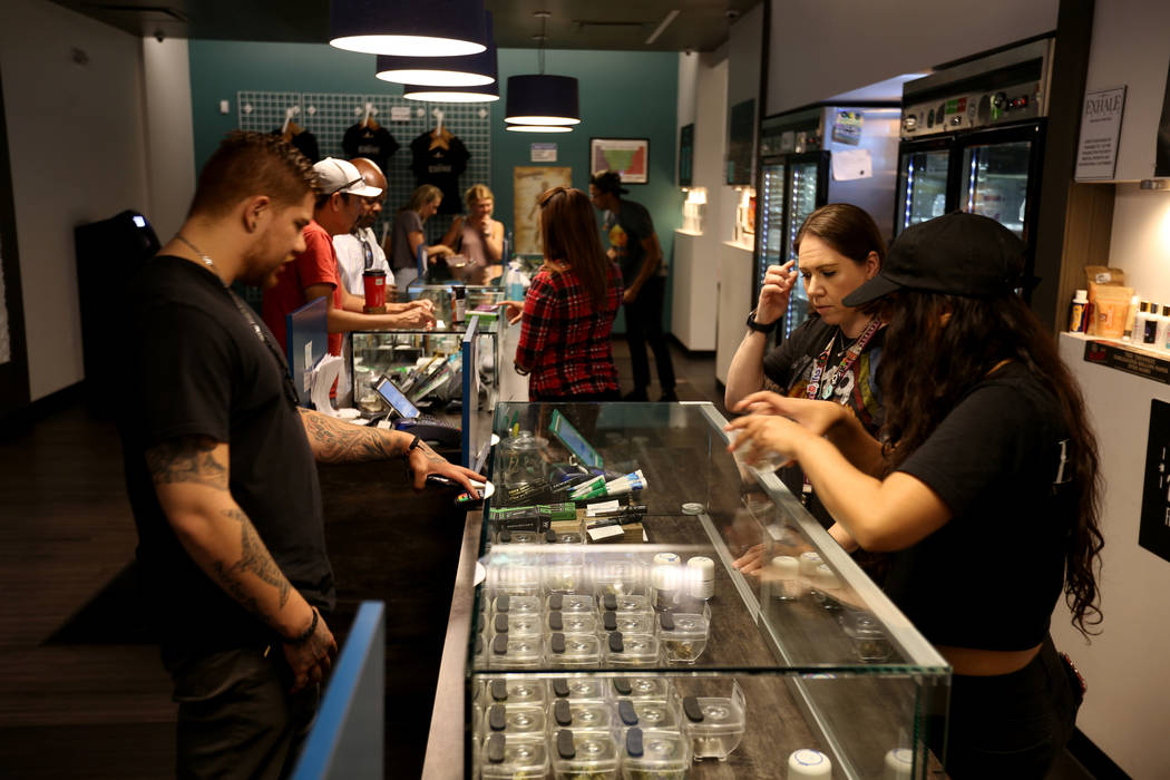 Eddie Medina of Seattle checks out product with Lindsay Steel, right, and Alyssa Jusino at Exhale Nevada marijuana dispensary in Las Vegas Thursday, June 28, 2018. K.M. Cannon Las Vegas Review-Jou ...