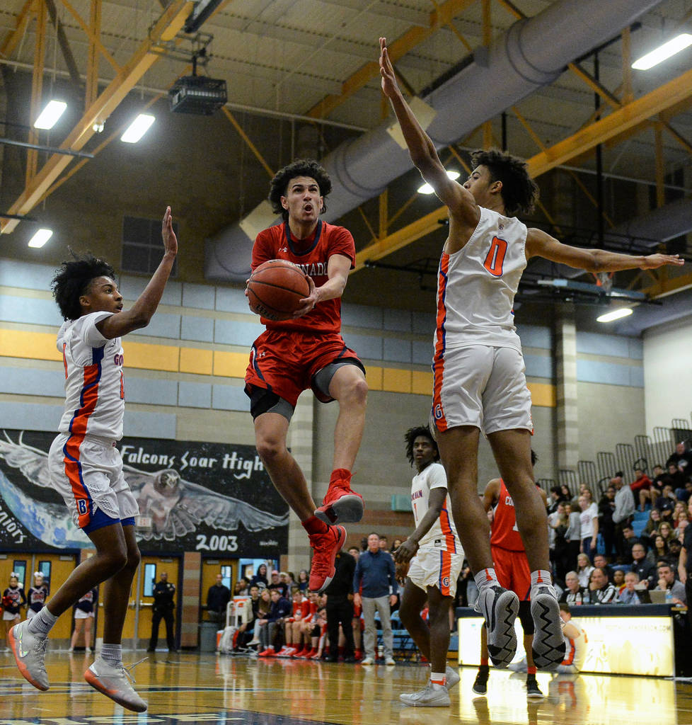 Coronado's Richard Isaacs (2) jumps up to take a shot while being guarded by Bishop Gorman's Zaon Collins (10), left, and Isaiah Cottrell (0) during the Desert Region boys semifinal game at Foothi ...