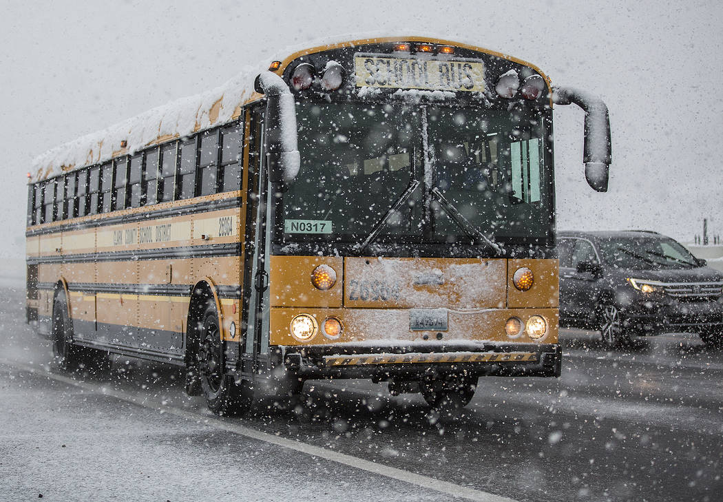 School buses make their way through heavy snow to Centennial High School on Thursday, Feb. 21, 2019, in Las Vegas. (Benjamin Hager Review-Journal) @BenjaminHphoto