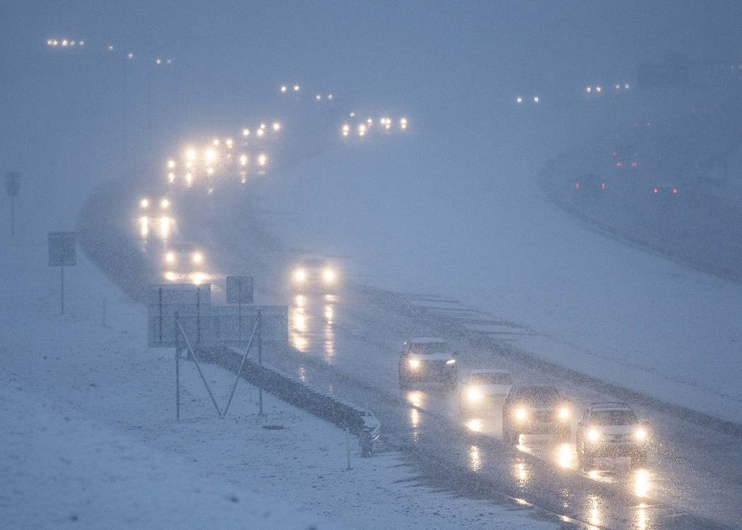Traffic makes their way through early morning snow on the 215 Beltway southbound close to the Hualapai Way exit on Thursday, Feb. 21, 2019, in Las Vegas. (Benjamin Hager Review-Journal) @BenjaminH ...