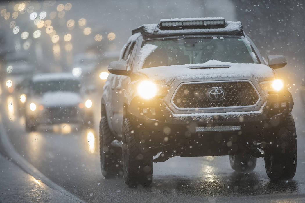 Traffic makes their way through early morning snow on U.S. Highway 95 southbound close to the Rancho Drive exit on Thursday, Feb. 21, 2019, in Las Vegas. (Benjamin Hager Review-Journal) @BenjaminH ...