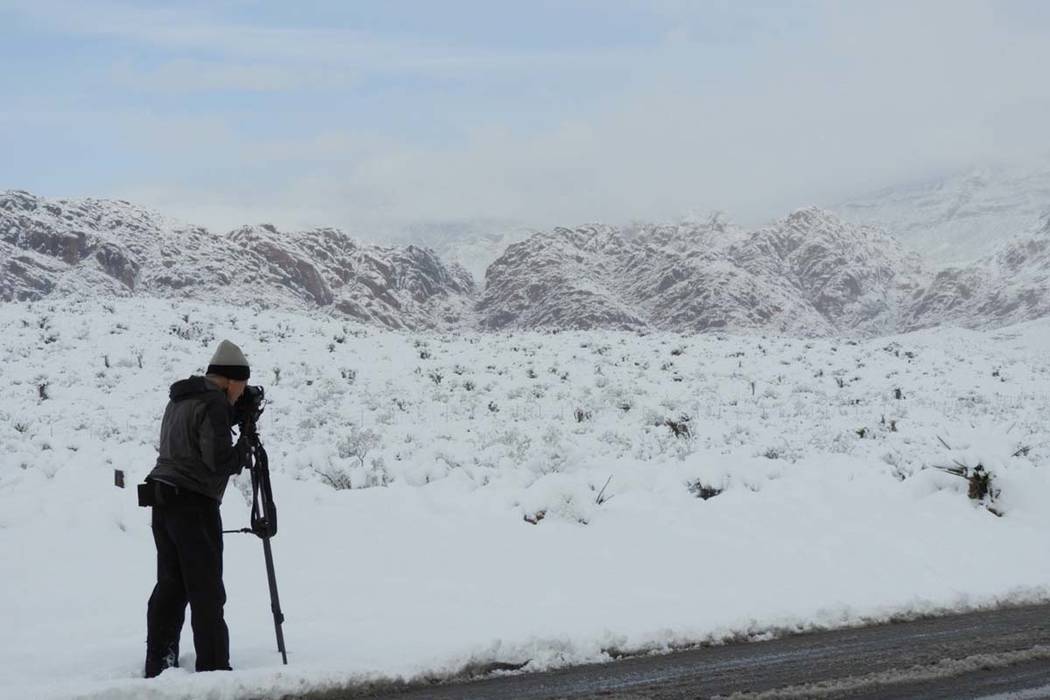 A photographer takes pictures of the snow at Red Rock on Thursday, Feb. 21, 2019. (Mat Luschek/Las Vegas Review-Journal)
