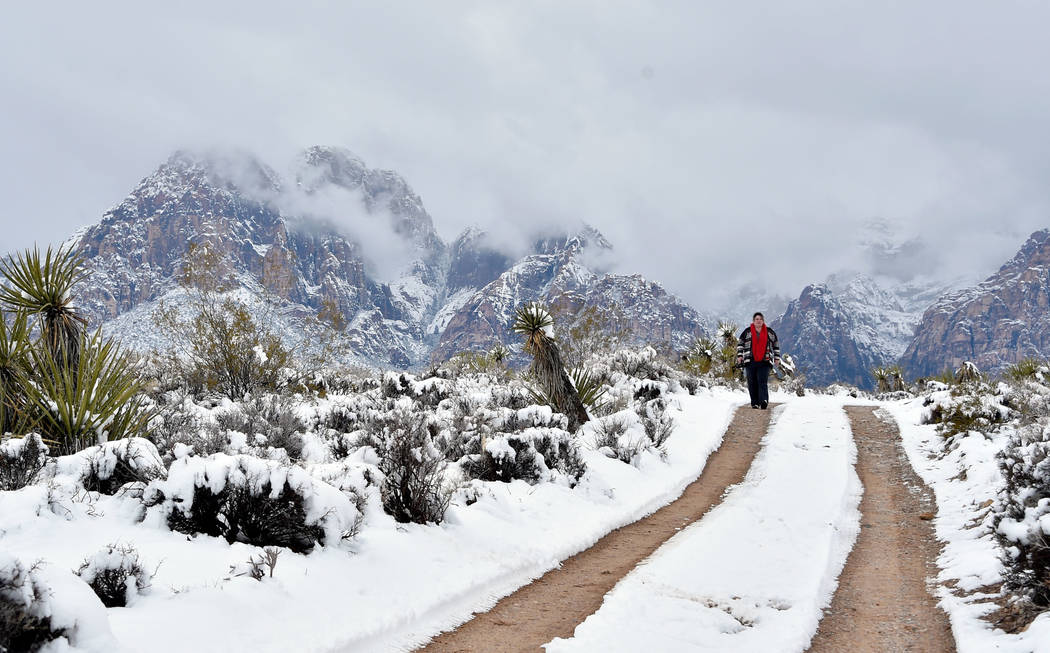 A woman hikes along a trail at Red Rock Canyon National Conservation Area Thursday, Feb. 21, 2019, in Las Vegas. Las Vegas experienced its most significant snowfall in over 10 years. (David Becker ...