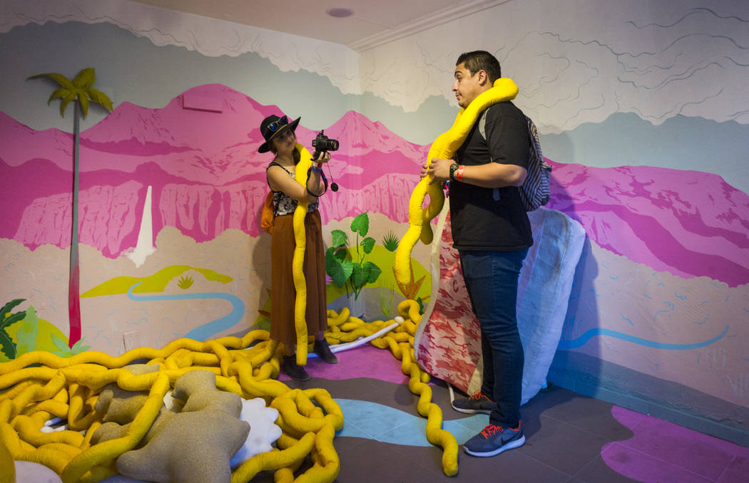 Katie Souther, left, takes a photo of Danny Cristales in an installation at the Art Motel by Meow Wolf during the first day of the Life is Beautiful festival in downtown in Las Vegas on Friday, Se ...