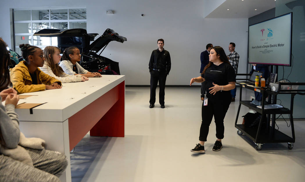 Middle school students listen to a lesson on electric motors as Tesla celebrates "Introduce a Girl to Engineering Day" at its Sahara showroom in Las Vegas, Thursday, Feb. 21, 2019. (Caroline Brehm ...
