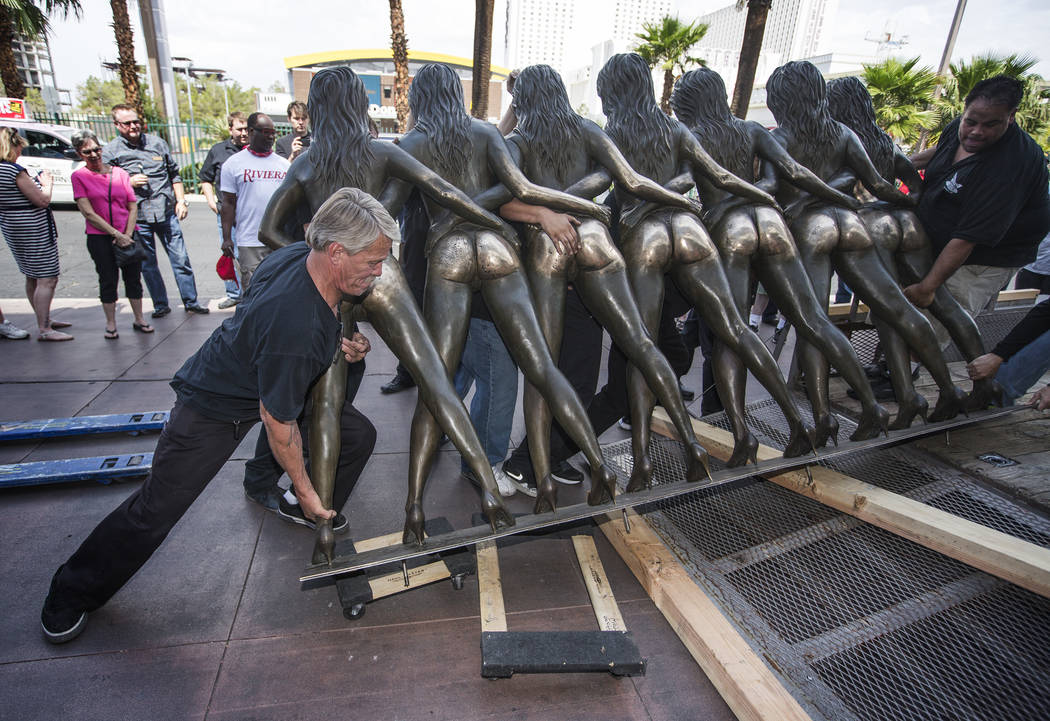 Dane Ironmonger helps load the Cazy Girls statue at the Riviera