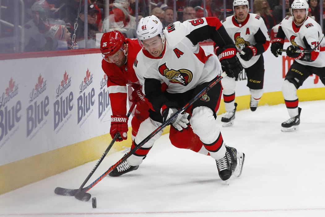 Ottawa Senators right wing Mark Stone (61) battles with Detroit Red Wings left wing Thomas Vanek (26) for the puck in the second period of an NHL hockey game Friday, Dec. 14, 2018, in Detroit. (AP ...
