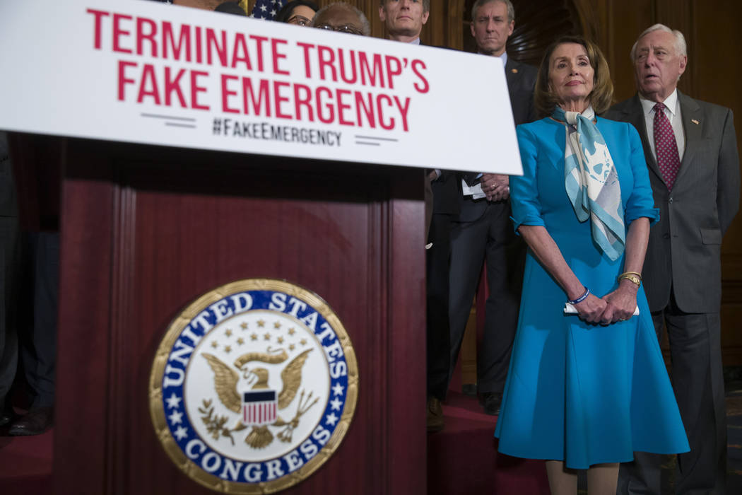 House Speaker Nancy Pelosi of Calif., left, stands with House Majority Leader Steny Hoyer of Md., and others, listens to a speaker about a resolution to block President Donald Trump's emergency bo ...