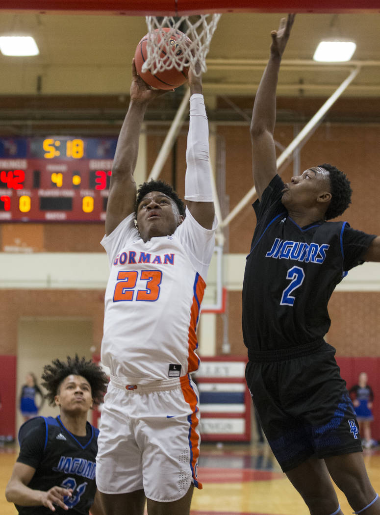 Bishop Gorman junior forward Mwani Wilkinson (23) drives past Desert Pines sophomore Dayshawn Wiley (2) in the third quarter during the Southern Nevada boys basketball championship game on Monday, ...