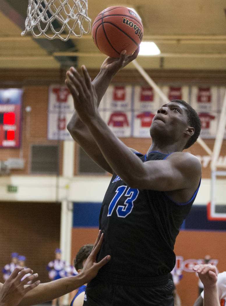 Desert Pines junior Darnell Washington (13) shoots a jump hook over Bishop Gorman defenders in the fourth quarter during the Southern Nevada boys basketball championship game on Monday, Feb. 25, 2 ...