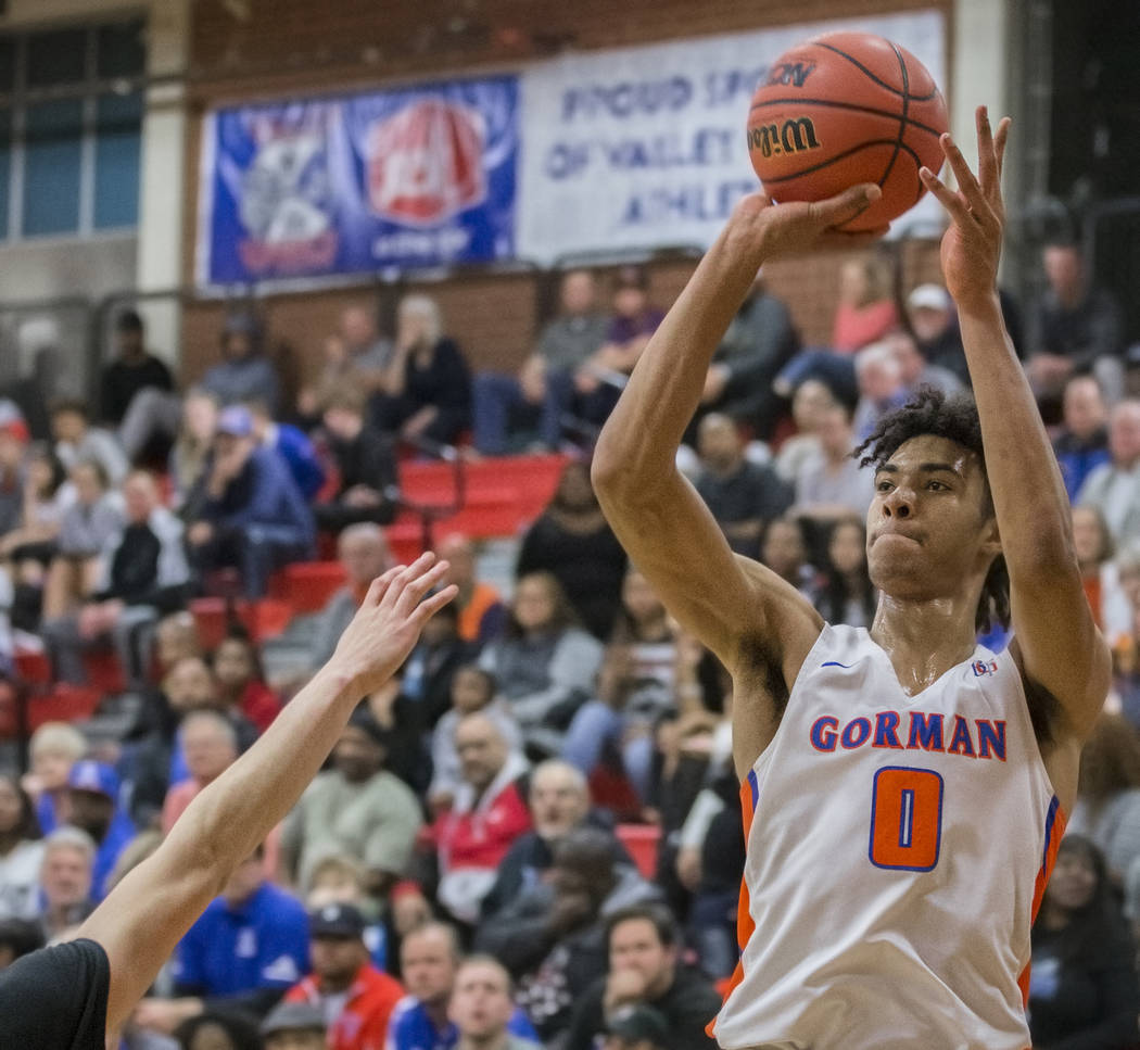 Bishop Gorman junior forward Isaiah Cottrell (0) shoots a corner three over a Desert Pines defender in the third quarter during the Southern Nevada boys basketball championship game on Monday, Feb ...
