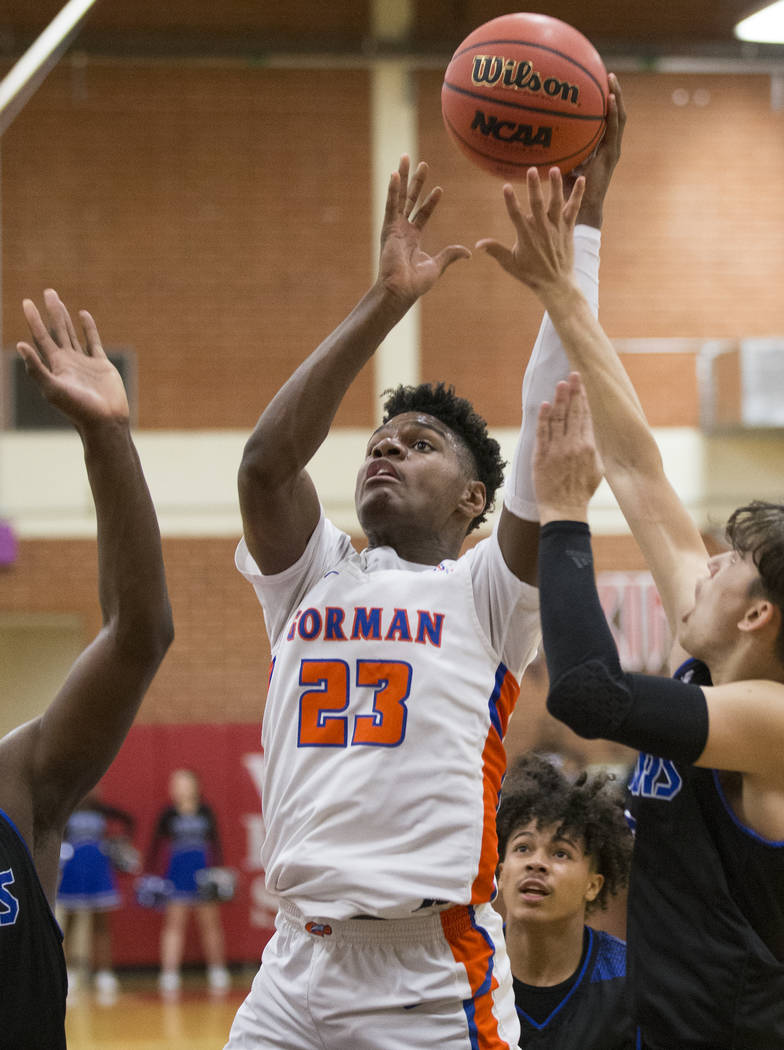 Bishop Gorman junior forward Mwani Wilkinson (23) shoots over Desert Pines sophomore Cimarron Conriquez (3) in the fourth quarter during the Southern Nevada boys basketball championship game on Mo ...
