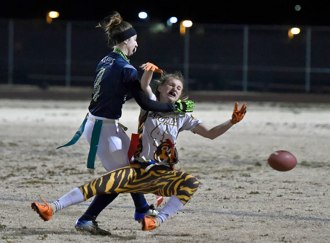 Green Valley's Hailee McKay, left, is called for pass interference against Bonanza's Shayne Dunn during Class 4A state flag football championship game at Cimarron High School Monday, Feb. 25, 2019 ...