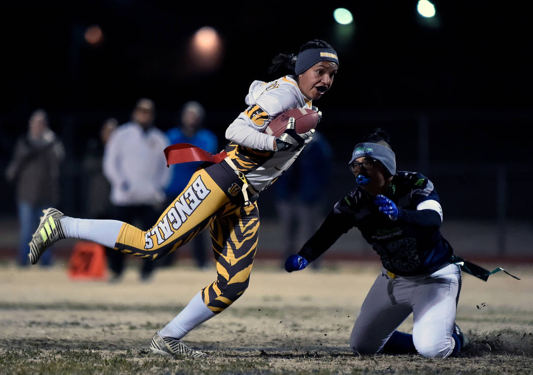 Bonanza's Ashley Vasquez (75) avoids a tackle from Green Valley's Anna Marie Arce during Class 4A state flag football championship game at Cimarron High School Monday, Feb. 25, 2019, in Las Vegas. ...