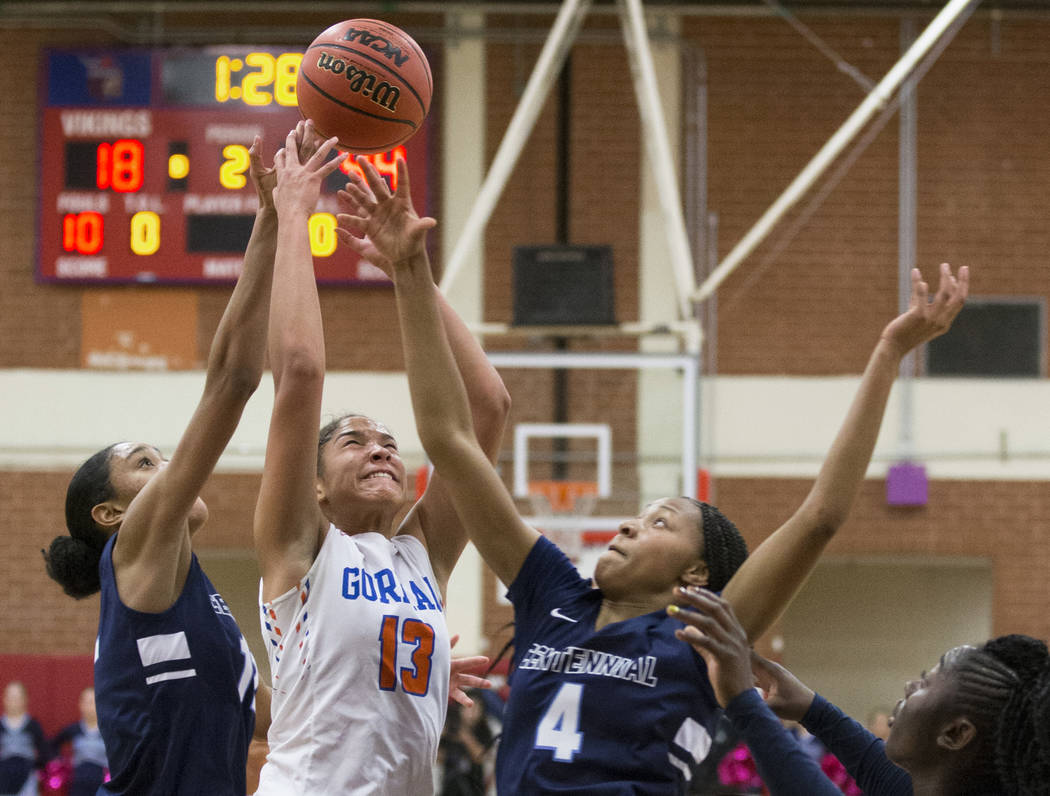 Bishop Gorman senior Georgia Ohiaeri (13) fights for a rebound with Centennial sophomore Taylor Bigby (4) in the second quarter during the Southern Nevada girls basketball championship game on Mon ...