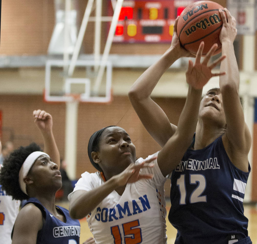 Centennial junior Aishah Brown (12) grabs a rebound over Bishop Gorman freshman Asya Bey (15) in the fourth quarter during the Southern Nevada girls basketball championship game on Monday, Feb. 25 ...
