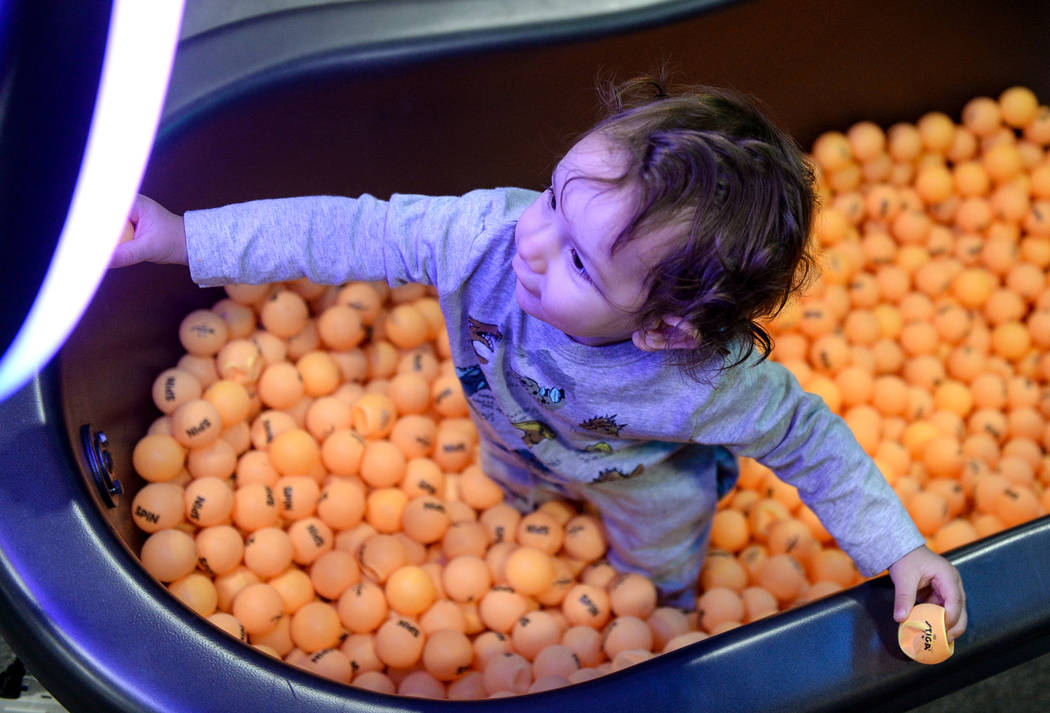 Atlas Varela, 13 months, sits in a bathtub full of ping pong balls at the Simple Booth stand at the Photo Booth Expo at the South Point Hotel and Casino in Las Vegas, Tuesday, Feb. 26, 2019. (Caro ...
