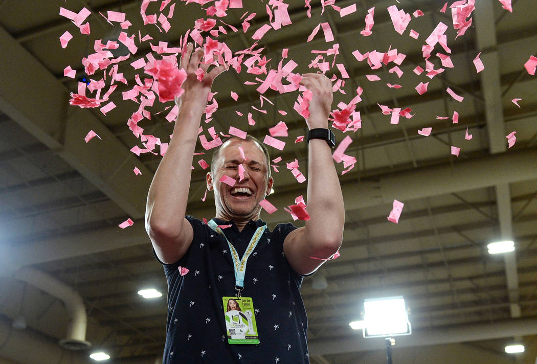 Brad Dixon throws up confetti as he gets his photo taken at the at theSlowGo 360 stand at the Photo Booth Expo at the South Point Hotel and Casino in Las Vegas, Tuesday, Feb. 26, 2019. (Caroline B ...