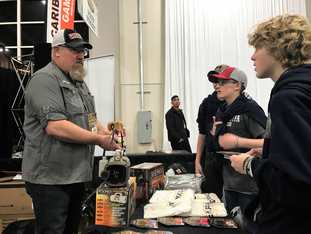 A group of young hunters listens intently while Al Morris, host of FOXPRO Hunting TV, shares the finer points of using an electronic game call to hail coyotes during the Western Hunting & Conserva ...