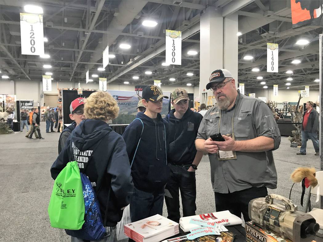 Al Morris, host of FOXPRO Hunting TV shares the finer points of using an electronic game call with a group of youthful hunters during the Western Hunting & Conservatin Expo in Salt Lake City, Utah ...