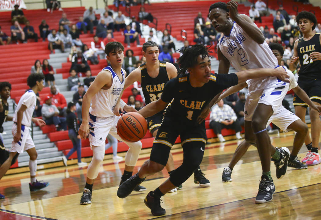 Clark's Frankie Collins (1) moves the ball around Desert Pines' Dayshawn Wiley (2) during the first half of a Class 4A state boys basketball quarterfinal game at Arbor View High School in Las Vega ...