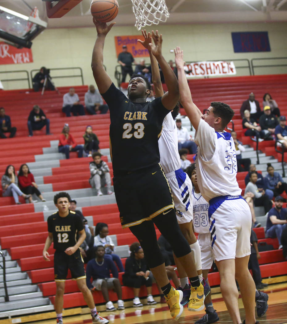 Clark's Antwon Jackson (23) shoots past Desert Pines' Jamir Stephens (33) during the second half of a Class 4A state boys basketball quarterfinal game at Arbor View High School in Las Vegas on Wed ...