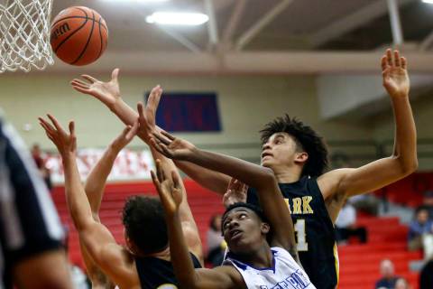Clark's Jalen Hill, right, battles for a rebound against Desert Pines' Dayshawn Wiley (2) during the second half of a Class 4A state boys basketball quarterfinal game at Arbor View High School in ...
