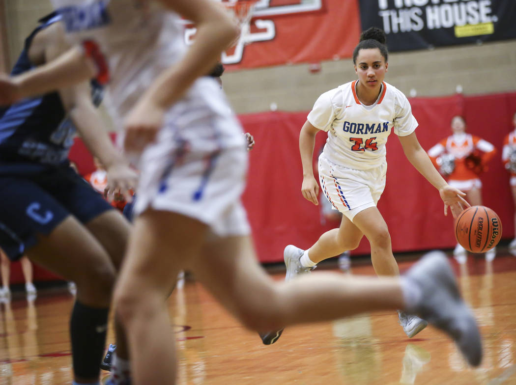 Bishop Gorman's Bentleigh Hoskins (24) brings the ball up court against Canyon Springs during the first half of a Class 4A state girls basketball quarterfinal game at Arbor View High School in Las ...