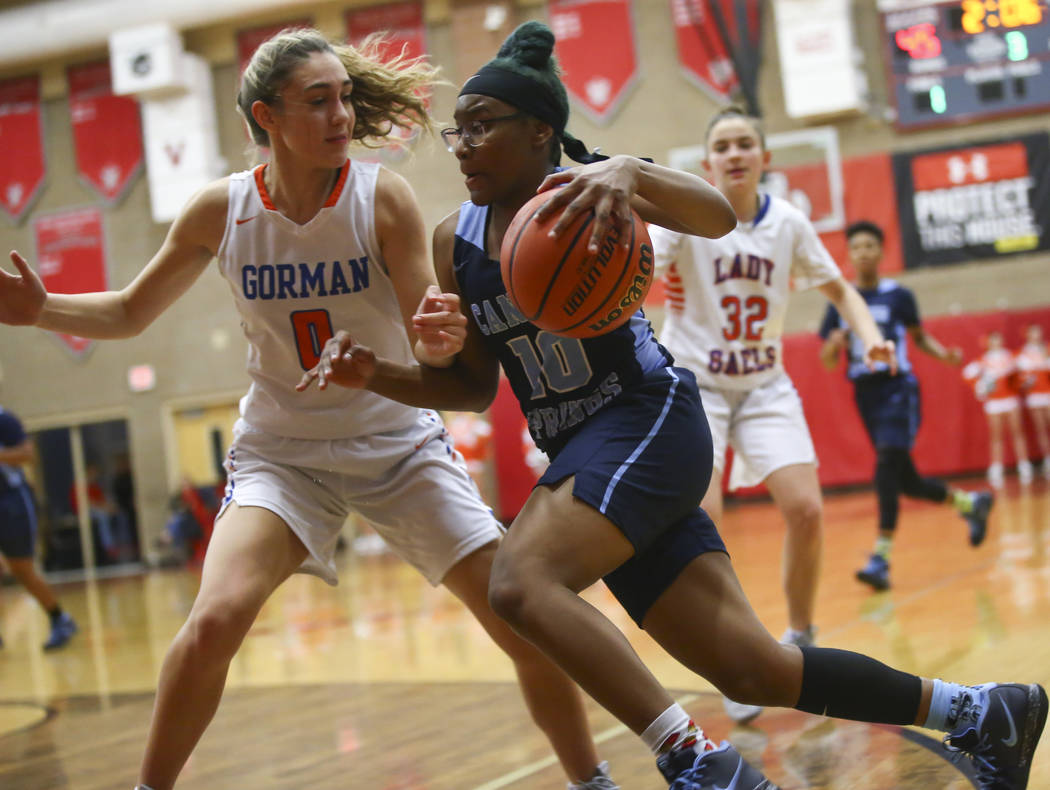 Canyon Springs' Sydnei Collier (10) drives the ball against Bishop Gorman's Izzy Westbrook (0) during the second half of a Class 4A state girls basketball quarterfinal game at Arbor View High Scho ...