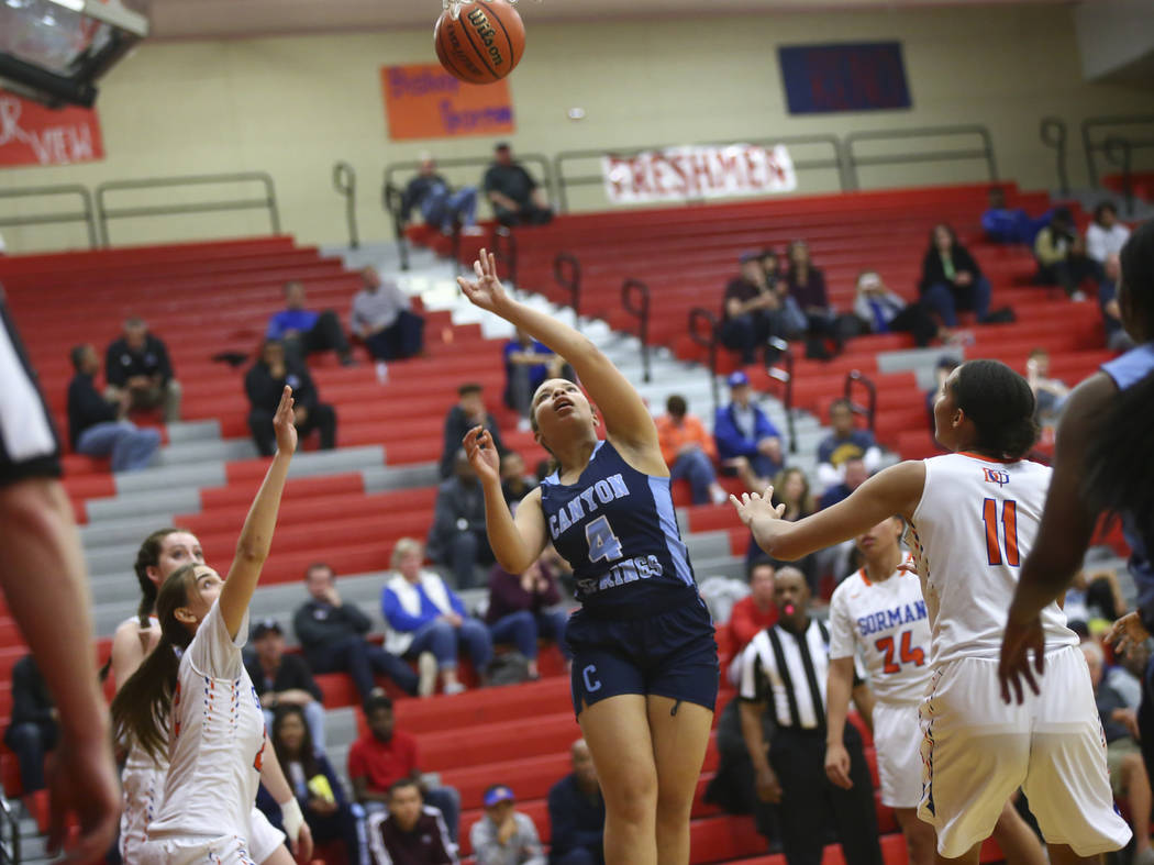 Canyon Springs' Jhane Richardson (4) shoots over Bishop Gorman's Olivia Smith (11) during the second half of a Class 4A state girls basketball quarterfinal game at Arbor View High School in Las Ve ...