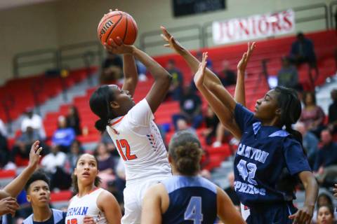 Bishop Gorman's Aaliyah Bey (12) shoots over Canyon Springs' Brooklyn Knox (42) during the first half of a Class 4A state girls basketball quarterfinal game at Arbor View High School in Las Vegas ...